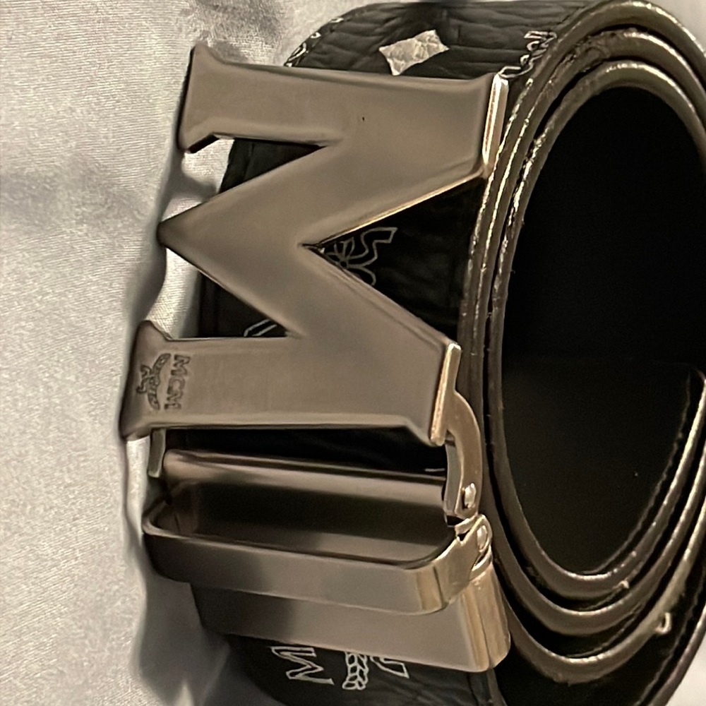 Black and white Mcm belt with silver buckle